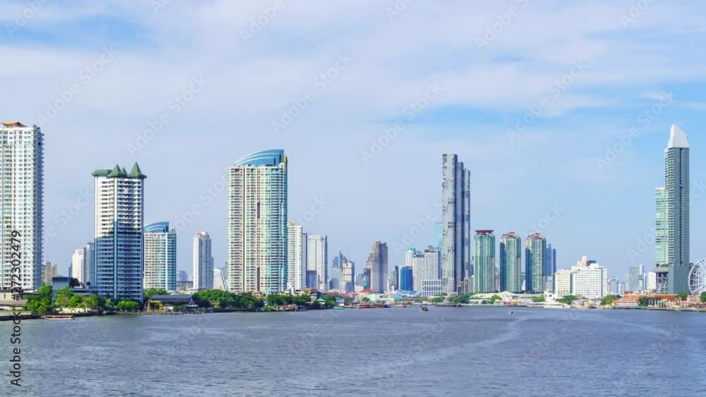 Time lapse: Bangkok waterfront cityscape and Chao Phraya River during sunny day. Pan right to left. Time lapse: Bangkok waterfront cityscape and Chao Phraya River during sunny day. Pan right to left.