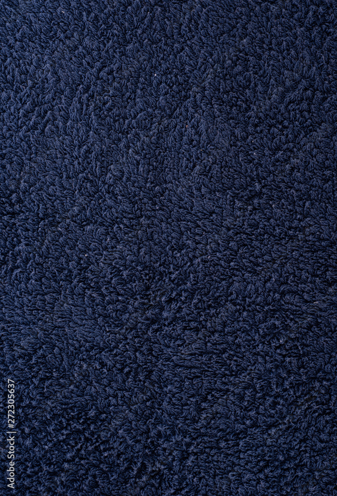 Fototapeta premium The texture of the fabric is dark blue terry towel. Terry cloth as a background.