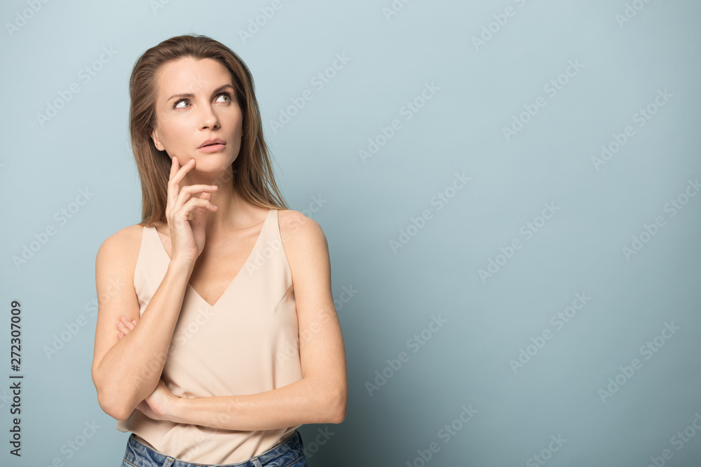 Attractive young woman touching her cheek, dreaming. Attractive young woman touching her cheek, dreaming.