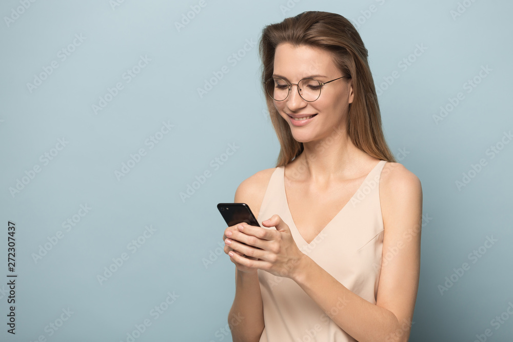Half side view happy woman in eyeglasses texting message. Half side view happy woman in eyeglasses texting message.