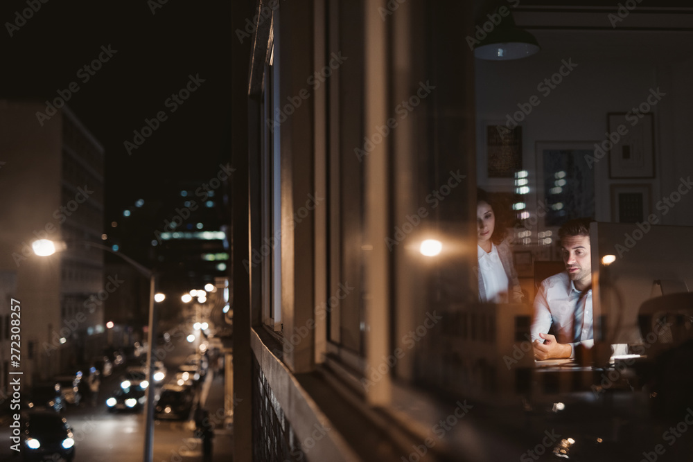 Business colleagues working late at night inside of an office