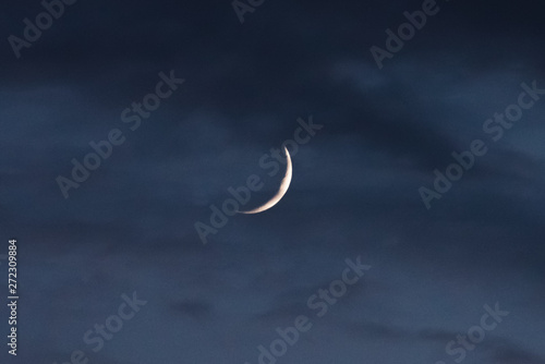 The new moon through the clouds