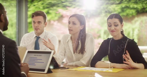 4K Businessman in a disciplinary meeting with mean, unfriendly management team. Slow motion.