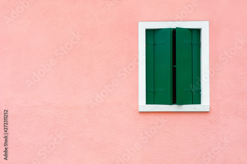 Fotografie Window with green shutters on the pink wall