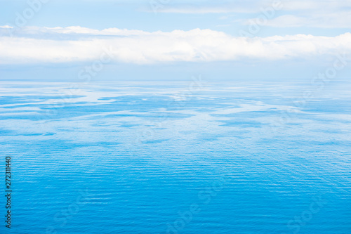 Blue sea background. Beautiful seascape and the blue sky with clouds