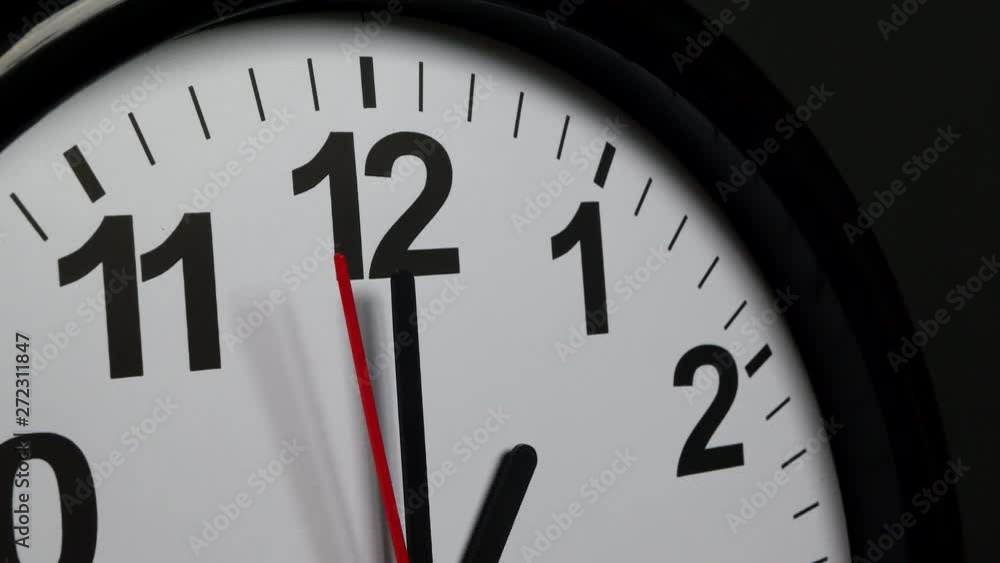 The Time On The Clock One. Black Clock With The Red Arrow Running In The Background Of The Arabic Numerals. The Time On The Clock One. Black Clock With The Red Arrow Running In The Background Of The Arabic Numerals.