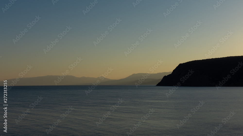 Beautiful sunset on the black sea, evening view of the mountains, Vesele bay in the Sudak Municipality of the Crimea