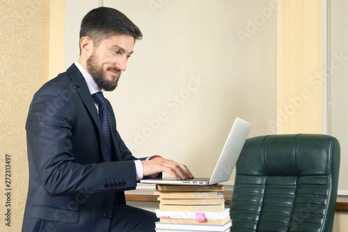 successful business man in office working with laptop