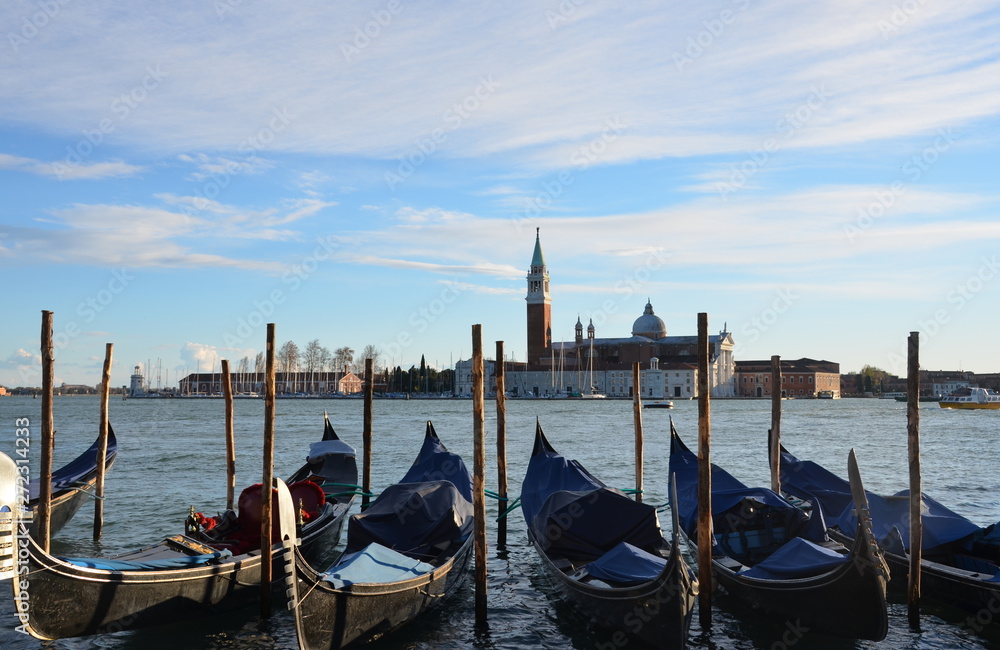 group of Gondolas moored by Saint Mark's square with San Giorgio di Maggiore church in Venice, Italy, Europe
