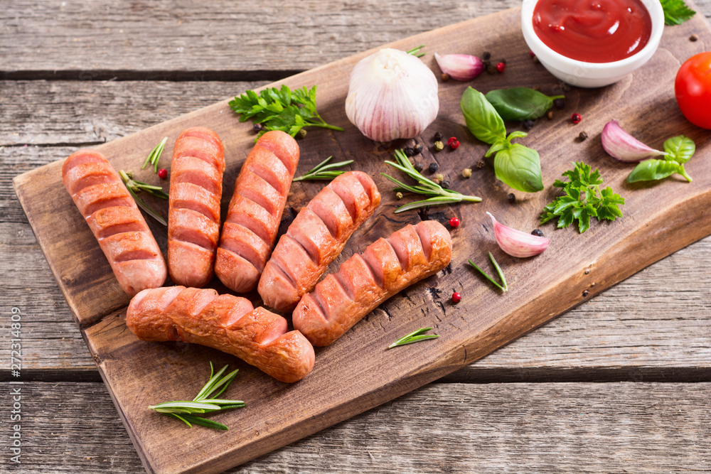 Fried sausages with herbs , spices and ketchup Fried sausages with herbs , spices and ketchup