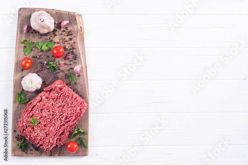 Raw minced beef meat with spices and herbs