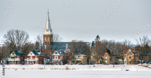 Church and street scene of houses in winter photo