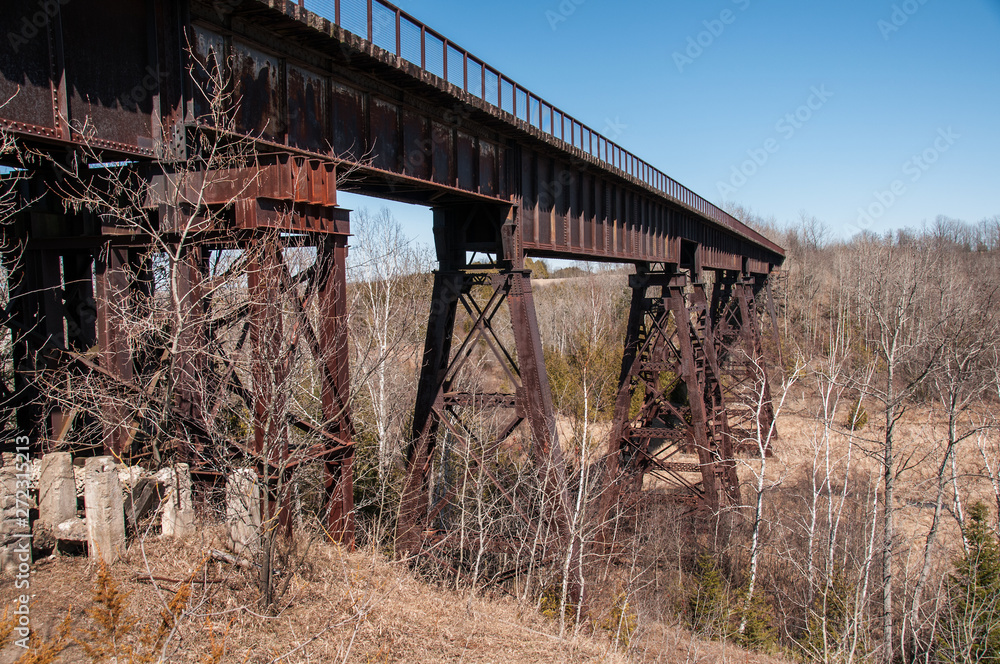 Old dilapidated rusty steel railway bridge