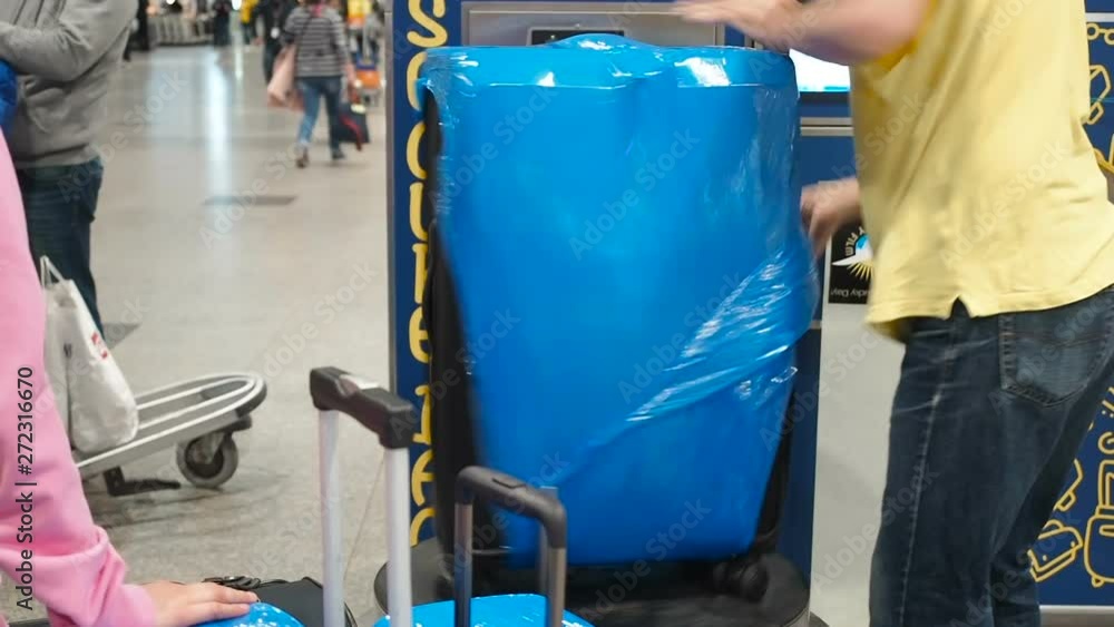 Luggage wrapping service at the airport, luggage is packed in