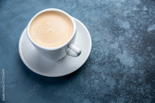 black coffee on blue pastel color background. Top view. Flat lay style