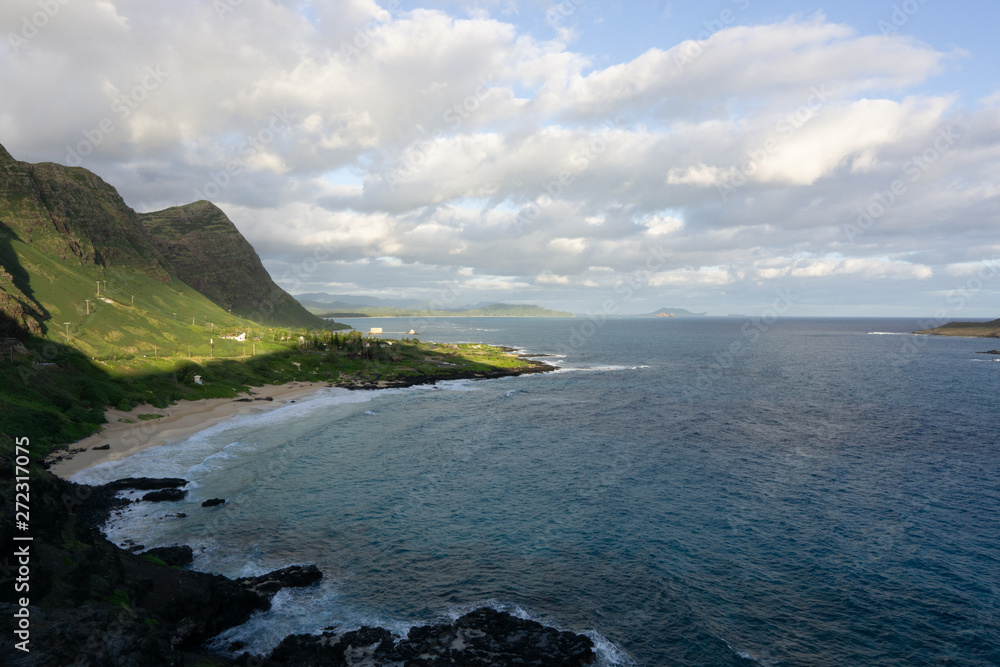 Oahu Hawaii windward shores of the island with Rabbit Island off shore greenery on sandy and rocky shores 