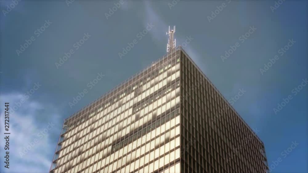 A light blinks on top of an antenna high atop a modern skyscraper ...