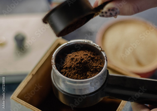 Top view on the preparation of fresh ground coffee in a coffee maker