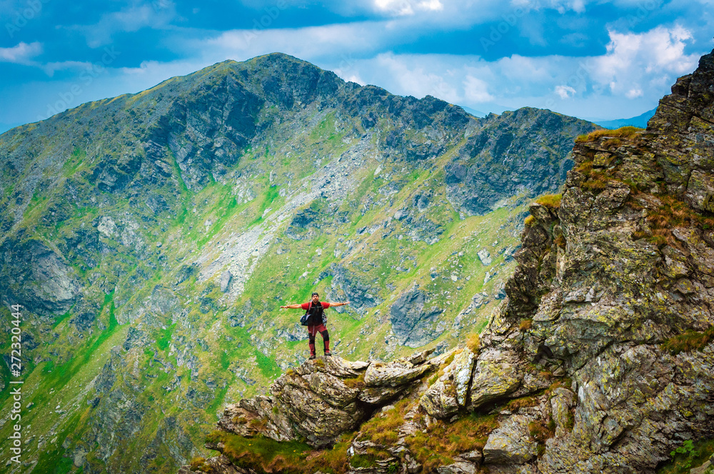 Hiker in beautiful mountain landscape, sense of freedom concept Hiker in beautiful mountain landscape, sense of freedom concept