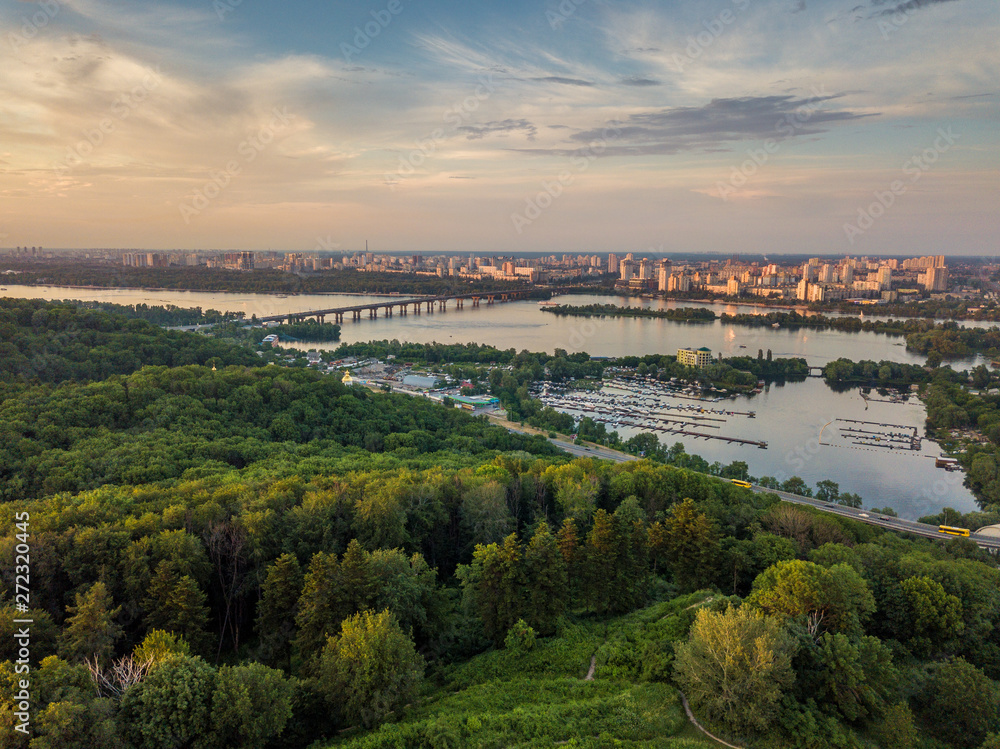 Panoramic view of Kyiv from the sky. Sunset over summer Kiev. Filmed on drone. Aerial view