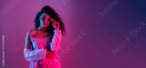 Fashion young african girl black woman wear stylish pink glasses clothes looking at camera isolated on party purple studio background, horizontal banner for website design, portrait, copy space