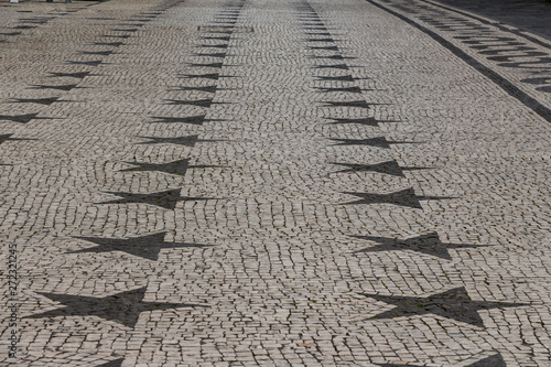 Typical, beautifully decorated cobbled stone streets of Ponta Delgada, capital city of Azores archipelago, Sao Miguel island. Black and white stone ornaments.