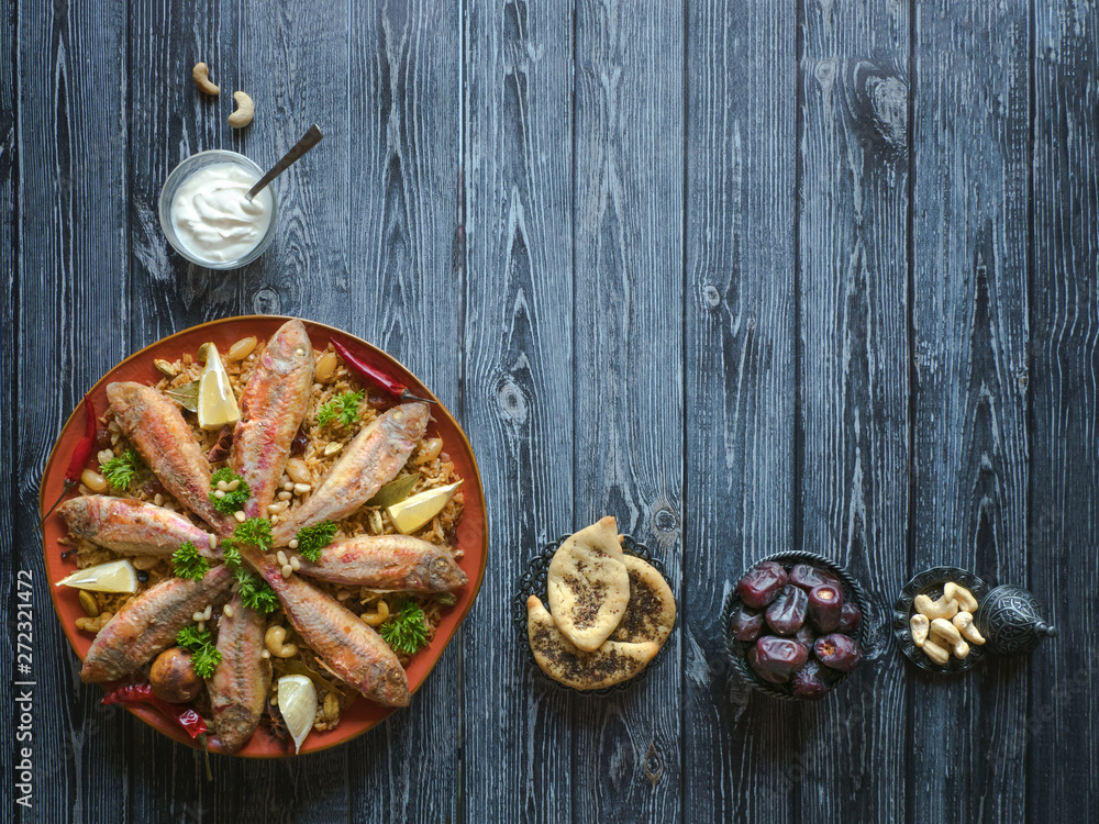 Arabian Fish Kabsa on a dark wooden background. Arabian Fish Kabsa on a dark wooden background.