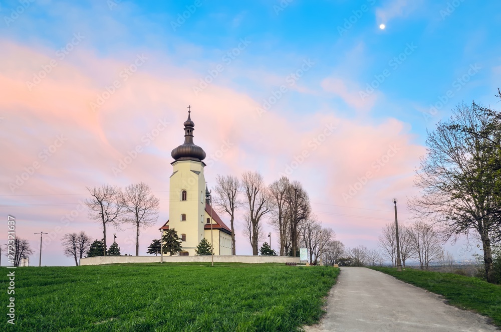 Beautiful church on the hill in the evening scenery. Church of St. Clement in Lędziny in Poland.