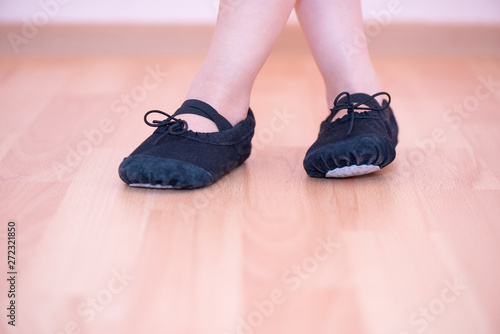 Detail of a little girl's feet with dance shoes 