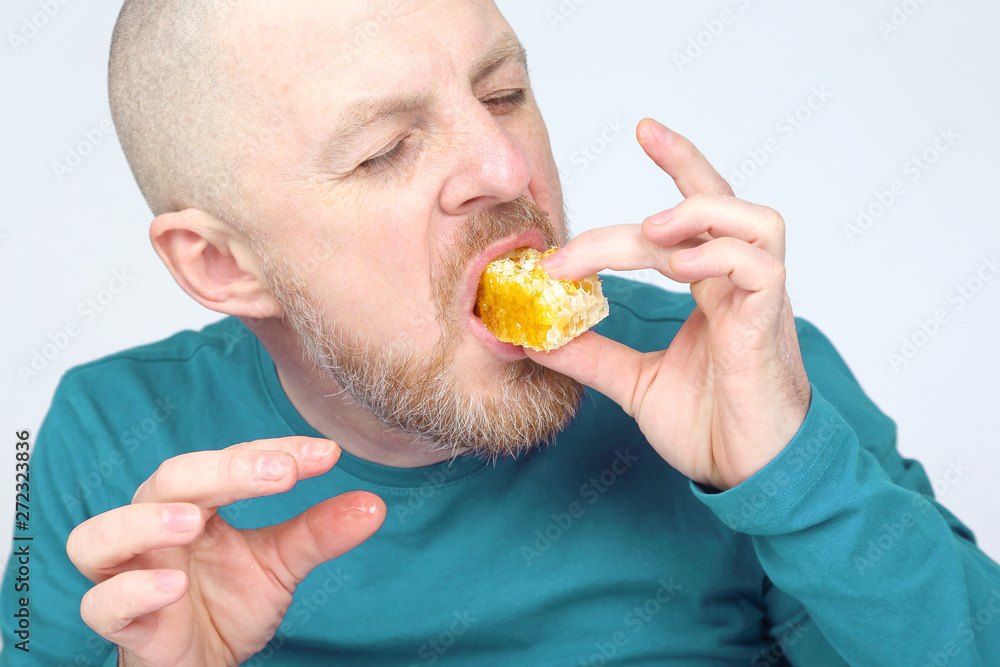 the man is appetizing eats honey. healthy and proper nutrition. the man is appetizing eats honey. healthy and proper nutrition.