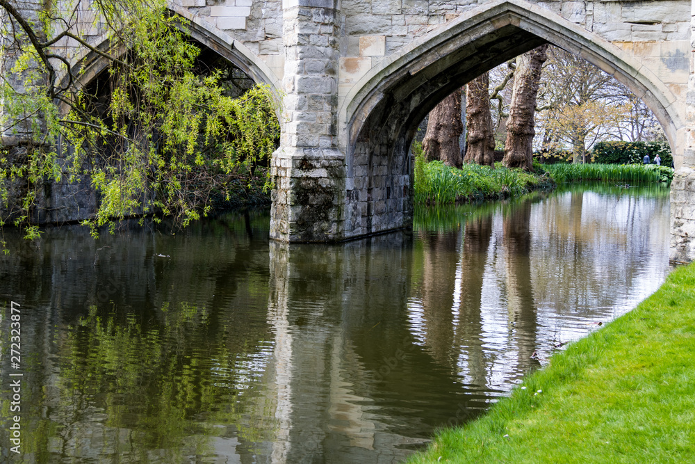 Reflections in the river, under the archways