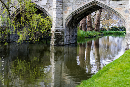 Photo Reflections in the river, under the archways