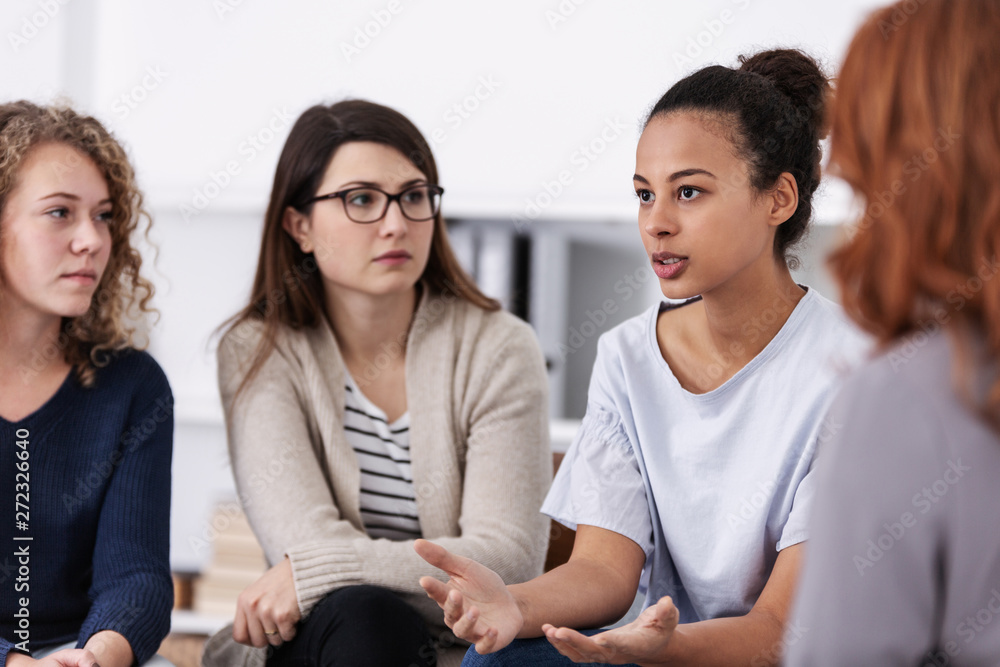 women supporting each other during psychotherapy group meeting - obrazy, fototapety, plakaty 