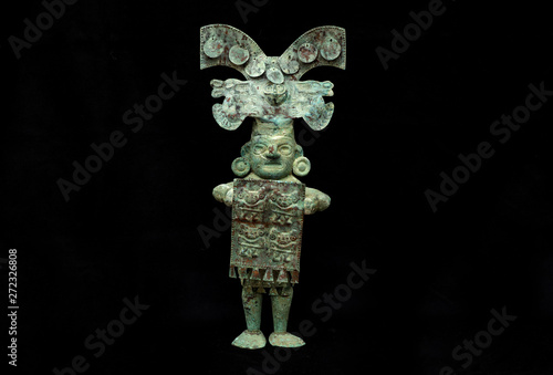 Pre-columbian copper men figure from Lambayeque ancient Peruvian culture. Pre inca handcrafted metallic piece made by ancient civilization. photo