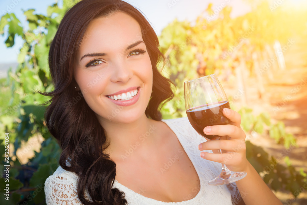 Beautiful Young Adult Woman Enjoying Glass of Wine Tasting In The Vineyard Beautiful Young Adult Woman Enjoying Glass of Wine Tasting In The Vineyard