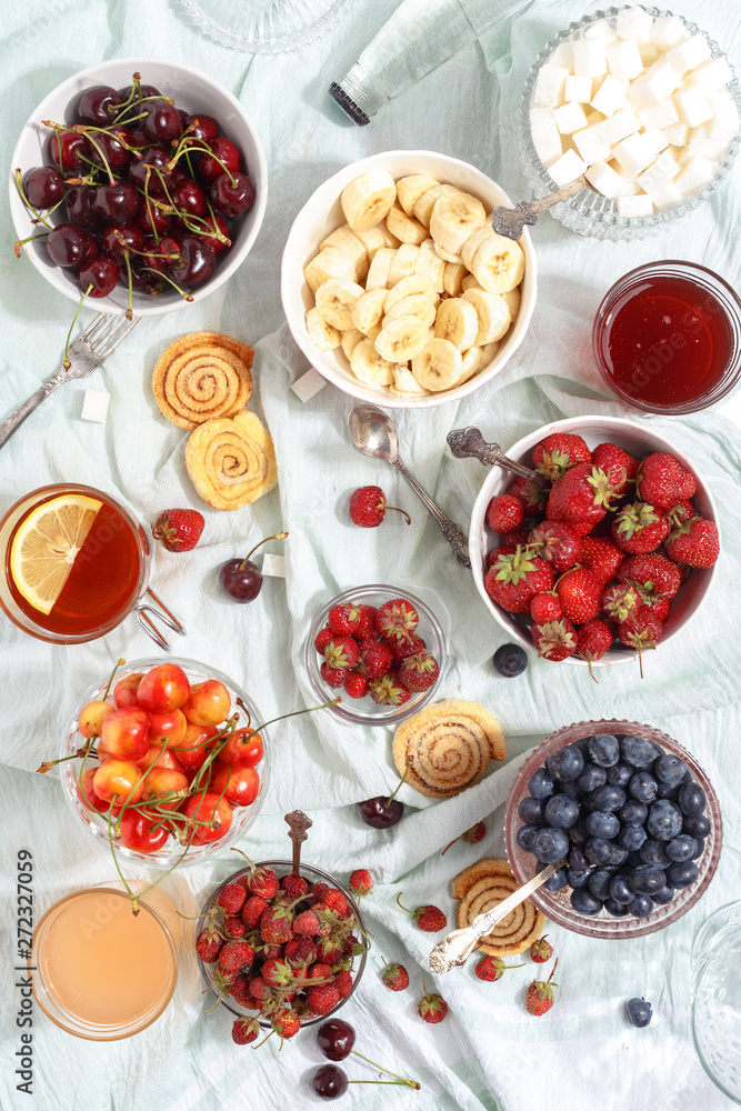 Summer berries strawberries, blueberries, sweet cherries in vases on the table. Top view Summer berries strawberries, blueberries, sweet cherries in vases on the table. Top view