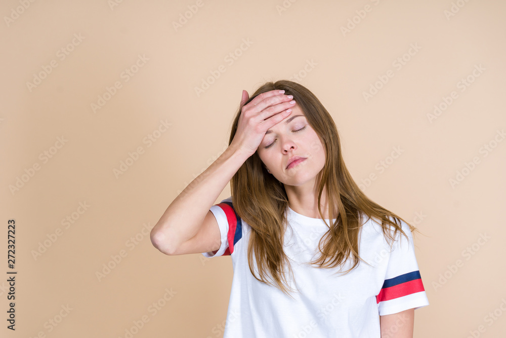 Front view of tired adult girl with closed eyes touching forehead Front view of tired adult girl with closed eyes touching forehead