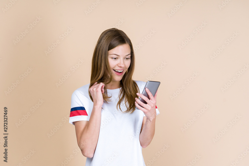 Front view of adult girl holding smartphone in hands Front view of adult girl holding smartphone in hands