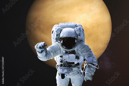 Fototapeta Naklejka Na Ścianę i Meble -  Astronaut in a front of Venus planet with atmosphere of solar system. Science fiction. Elements of the image were furnished by NASA