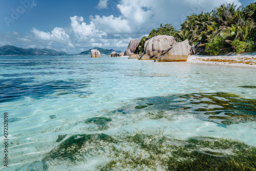 Well known beautiful Anse Source D'Argent beach with shallow blue lagoon and granite boulders, La Digue Island, Seychelles. Luxury paradise travel concept