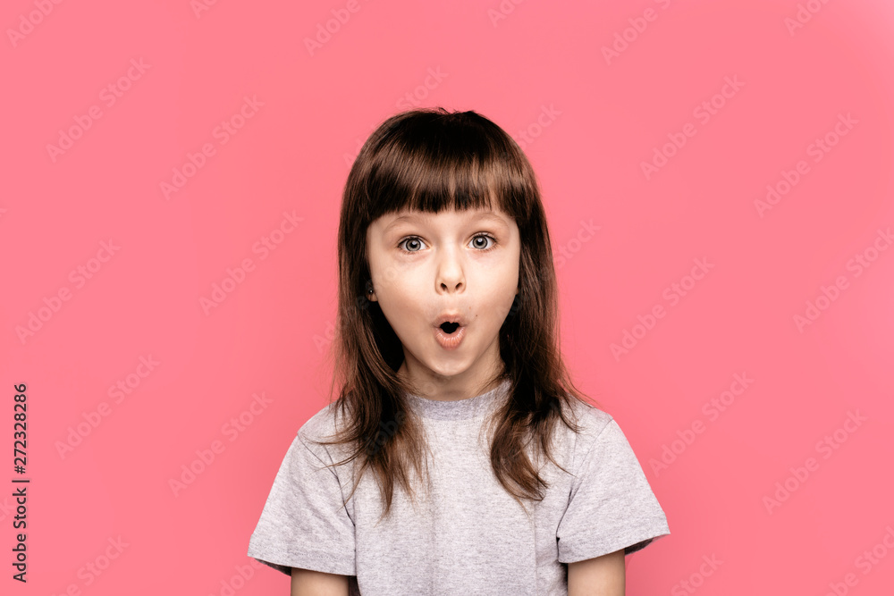 Wow! Surprise and shock. It's amazing news. Little child girl showing overjoy emotions over pink studio background. Human emotions, lifestyle, freestyle, smile, blank, funny gesture. Wow! Surprise and shock. It's amazing news. Little child girl showing overjoy emotions over pink studio background. Human emotions, lifestyle, freestyle, smile, blank, funny gesture.