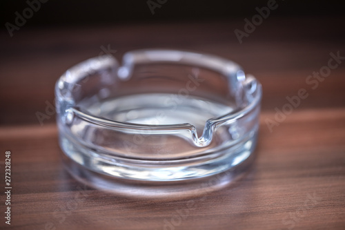 Glass Ashtray closeup on wooden table