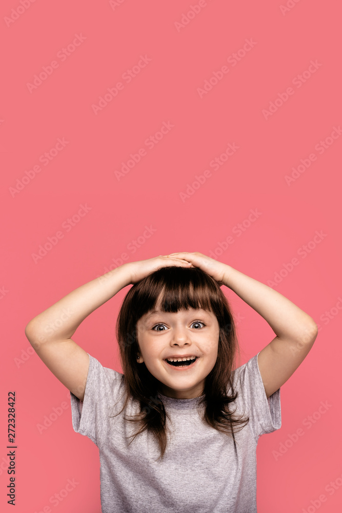 Oh yes finally I gained it! Overjoyed pleased little girl raises clenched fists, shows her beautiful happy smile, wears grey t-shirt, models over pink background, celebrates excellent news. Oh yes finally I gained it! Overjoyed pleased little girl raises clenched fists, shows her beautiful happy smile, wears grey t-shirt, models over pink background, celebrates excellent news.