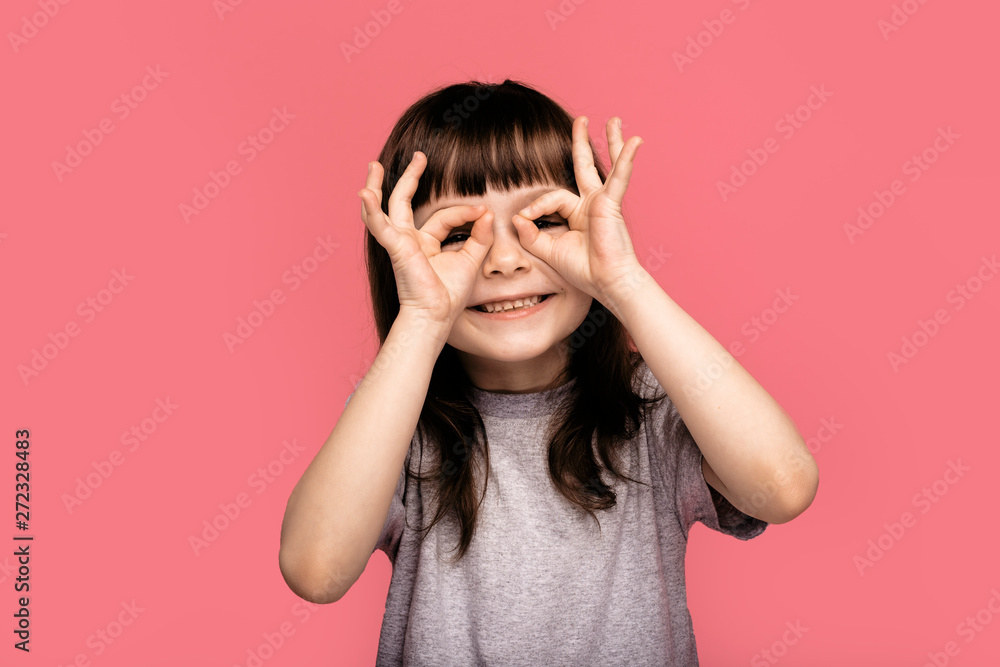 Close up photo careless nice cute little girl content candid rejoice laughter free time weekend toothy shiny cute make spectacles fingers shape fool fashionable jeans clothes isolated pink background Close up photo careless nice cute little girl content candid rejoice laughter free time weekend toothy shiny cute make spectacles fingers shape fool fashionable jeans clothes isolated pink background