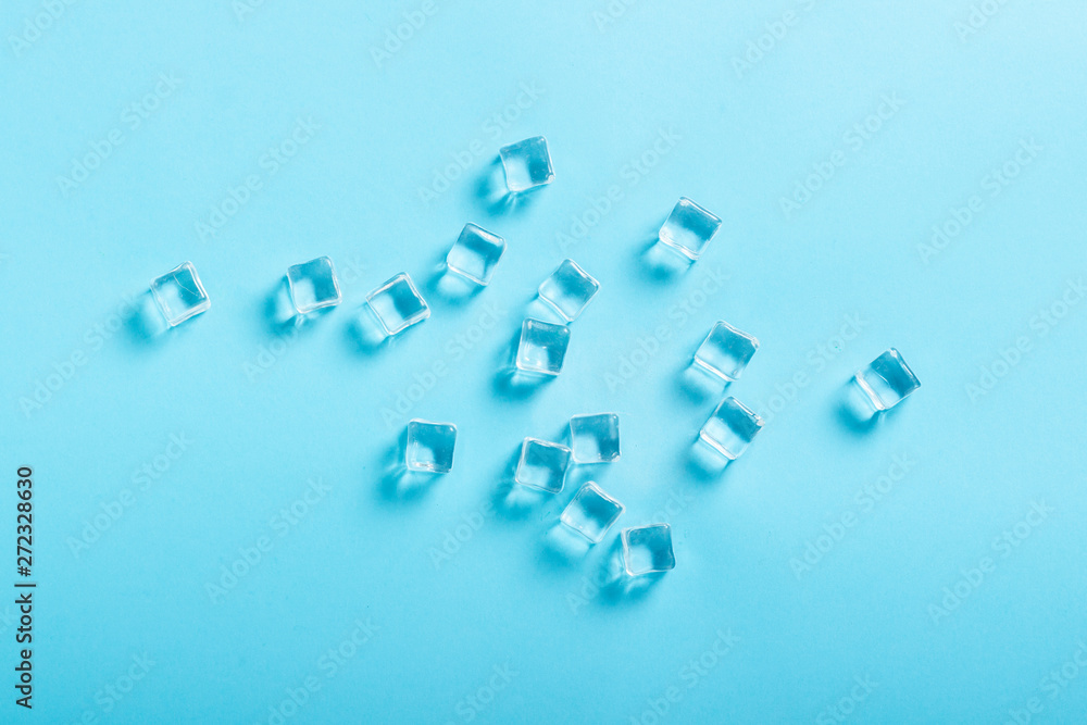 Ice cubes on blue background. Flat lay, top view Ice cubes on blue background. Flat lay, top view