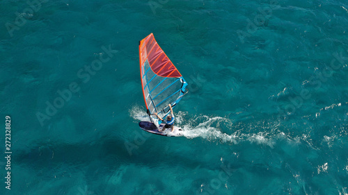 Obraz na plátně Aerial photo of surfer cruising in high speed in Mediterranean destination bay w