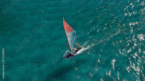 Aerial photo of surfer cruising in high speed in Mediterranean destination bay with deep blue sea