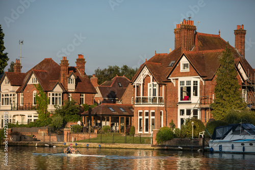 Rowers on the river Thames at Marlow on a warm summer evening in Buckinghamshire, UK