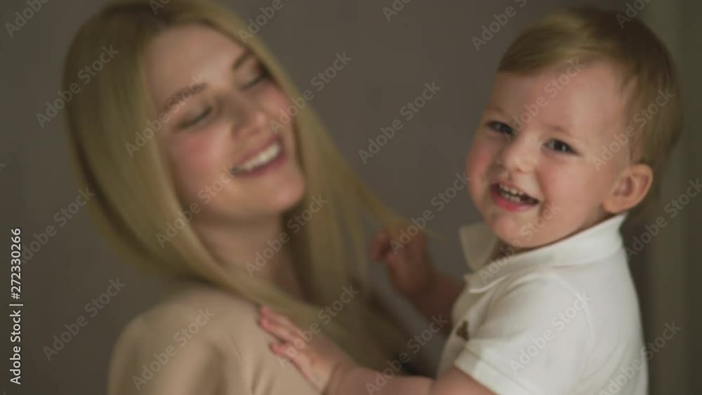 Beautiful young blonde mom playing with her baby boy son - Family values goal - Caucasian mother and child at home - Smooth cinematic handheld movement Beautiful young blonde mom playing with her baby boy son - Family values goal - Caucasian mother and child at home - Smooth cinematic handheld movement