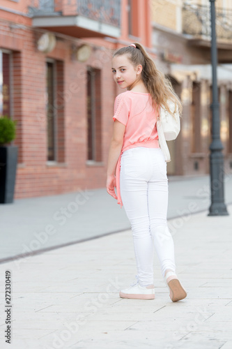 She is really cute. Little child with long blond hair in casual fashion style. Adorable child on summer day. Fashionable girl child on city street. Small child with beauty look © be free